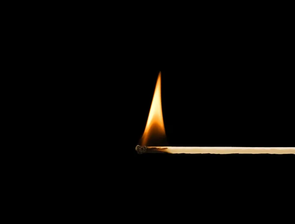 Burning match on a black background — Stock Photo, Image