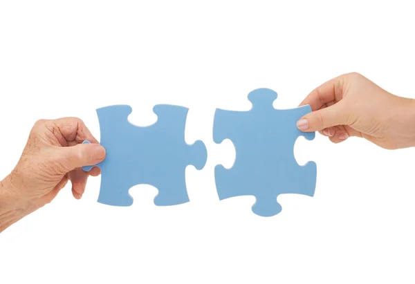 Hands and puzzle, isolated — Stock Photo, Image