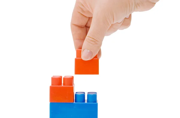 Hand with the toy block isolated — Stock Photo, Image