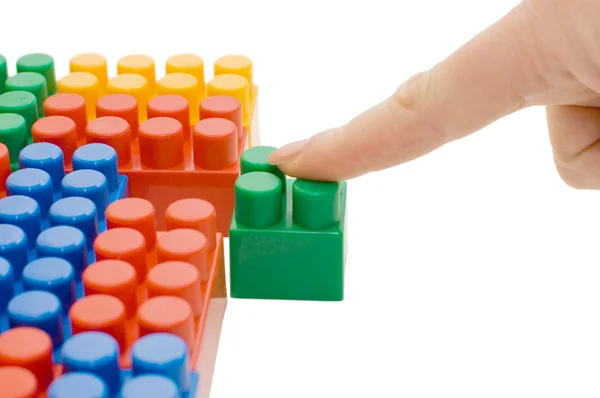 Mão com o bloco de brinquedo isolado — Fotografia de Stock