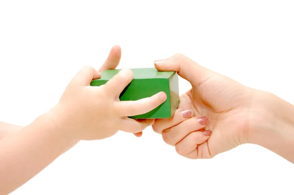 Cube in female and children's hands isolated — Stock Photo, Image