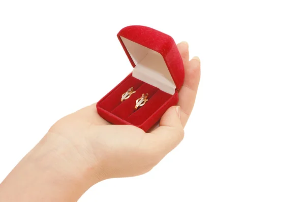 Caixa vermelha com uma jóia em uma mão — Fotografia de Stock