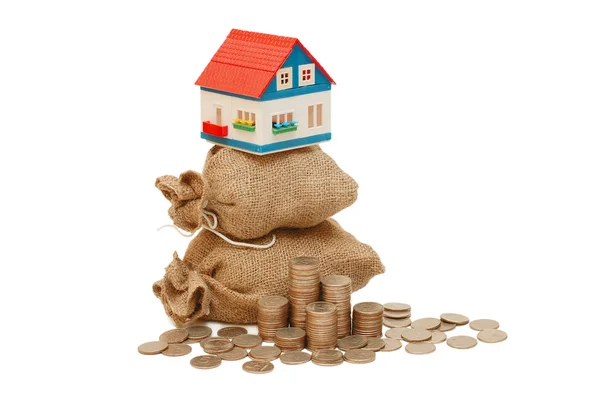 The toy house on bags with coins — Stock Photo, Image