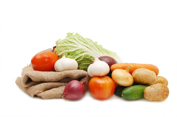 Frisches Gemüse und Säcke auf weiß — Stockfoto