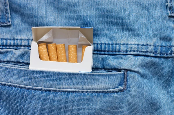 Jeans pocket with a packet of cigarettes — Stock Photo, Image