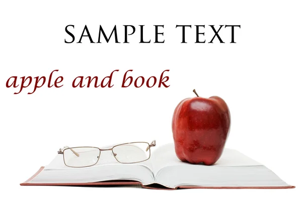 Червоне яблуко і окуляри на книзі — стокове фото