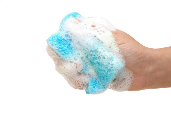 Hand and kitchen sponge in soapsuds — Stok fotoğraf