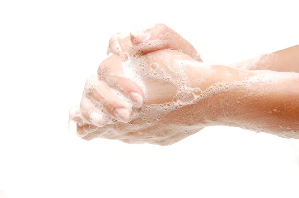 Les mains féminines dans des savons isolés — Photo
