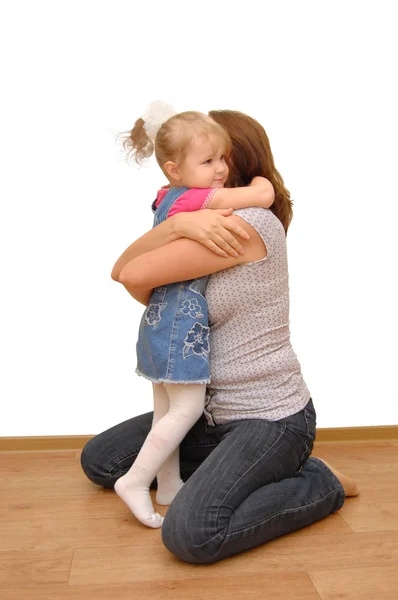 Mother and her little daughter on wooden floor — Stock Photo, Image