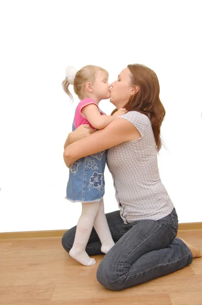 Mother and her little daughter on wooden floor — Stock Photo, Image