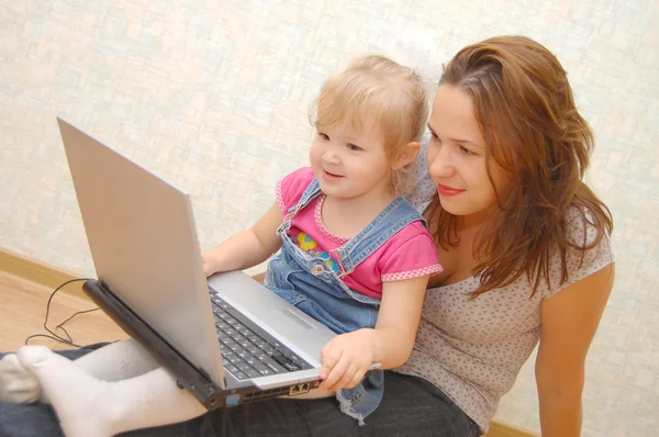 Mother and Daughter Using Laptop on wooden floo — Stock Photo, Image