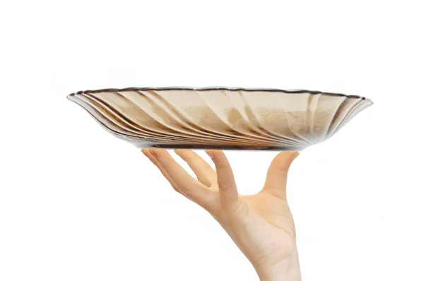 Empty glass dish in a female hand — Stock Photo, Image