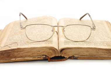 Old book and glasses on it clipart