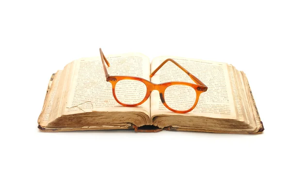 Open old book and glasses — Stock fotografie