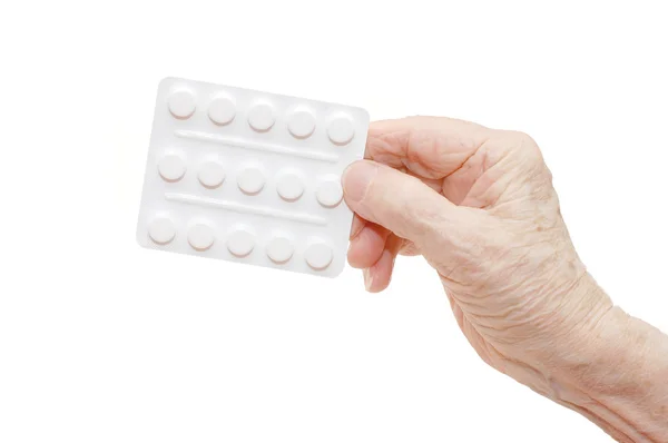 Senior hand with tablets isolated — Stock Photo, Image