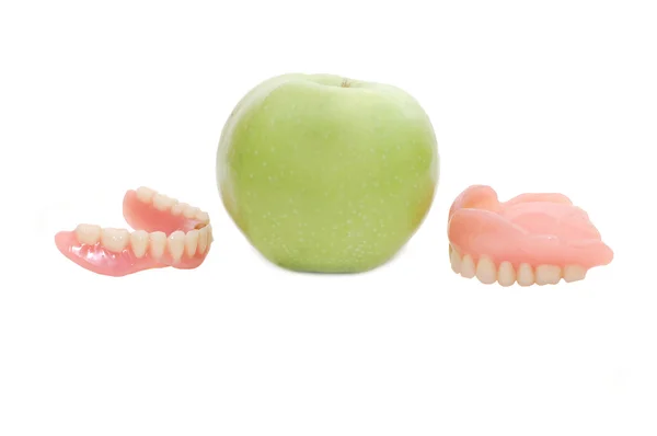 Dentures with green apple — Stock Photo, Image