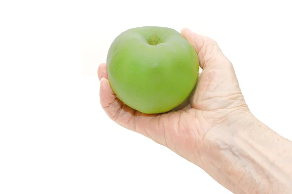 Mão da senhora idosa que segura a maçã — Fotografia de Stock