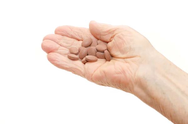 Senior hand med tabletter isolerade — Stockfoto