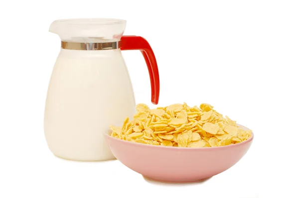 Jug of milk and plate of corn flakes — Stock Photo, Image