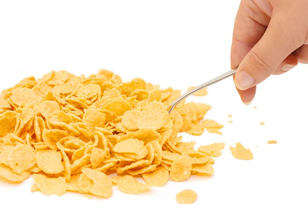 Hand with a spoon of corn flakes — Stock Photo, Image