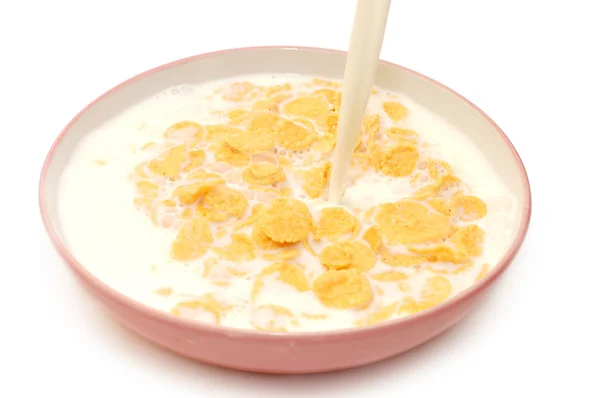 Corn flakes in bowl with milk — Stock Photo, Image