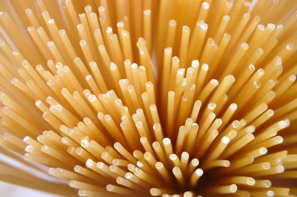 Uncooked spaghettis background — Stock Photo, Image