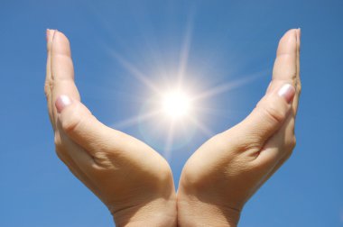 Female hands touching the Sun clipart