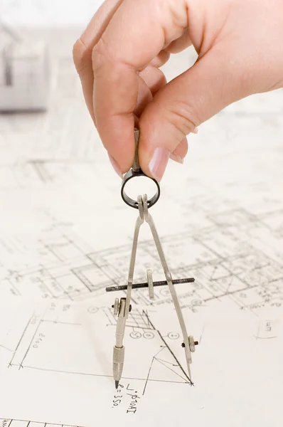 Architects compass in a female hand — Stock Photo, Image