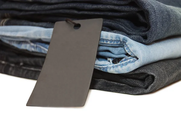 Mucchio di jeans isolato su bianco — Foto Stock