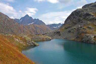 Turquoise lake in the mountains clipart