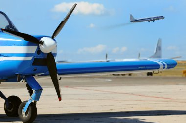 Small propeller airplane at the airfield clipart