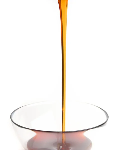 Honey pouring into the honey pot — Stock Photo, Image