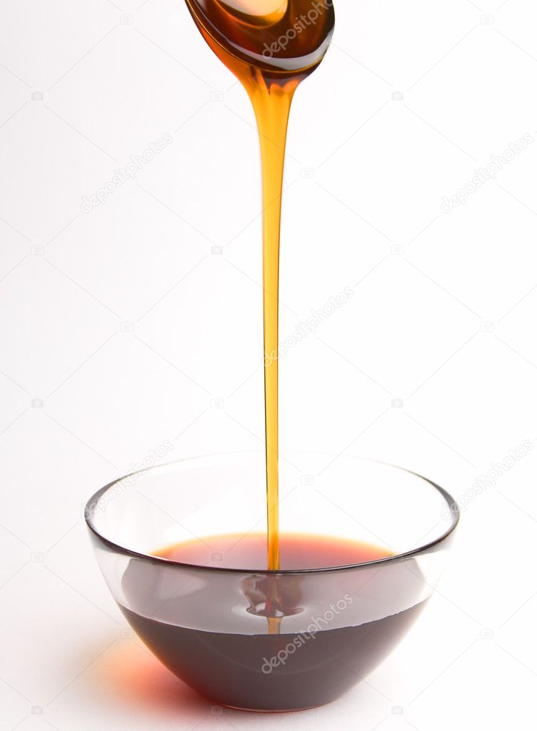 Honey pouring from the spoon