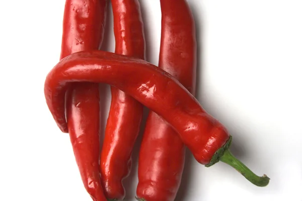 Four red hot chilli peppers closeup — Stock Photo, Image