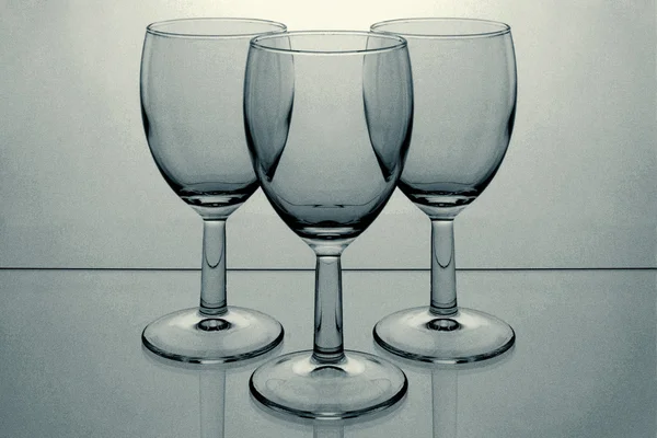 Three glasses on light background — Stock Photo, Image