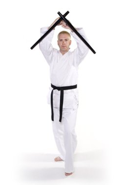 First Degree Black Belt with tonfa. clipart