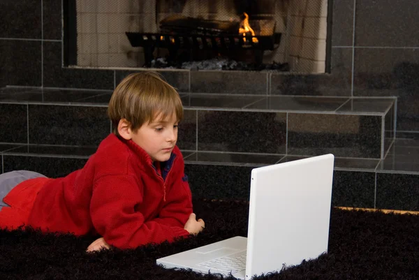 Boy at Fireplace on Computer — Stock Photo, Image