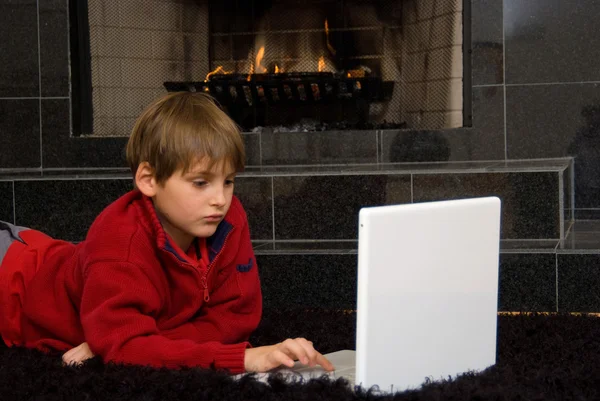 Boy at Fireplace on Computer — Stock Photo, Image