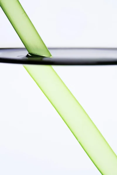 Drinking straw refracted by water — Stock Photo, Image