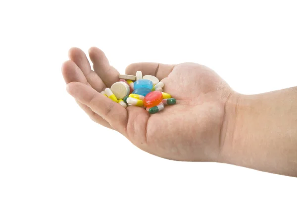 Рука с таблетками — стоковое фото