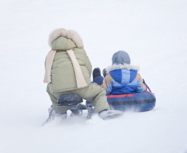 Children on a sled clipart