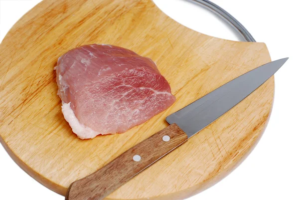Pork meat & knife on cutting board Stock Image