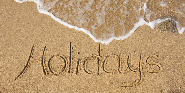 The inscription on the sand - holidays, vacation paradise...
