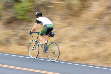 Man cyclist racing past clipart