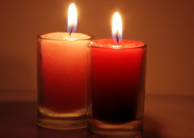 Two red candles burning against clipart