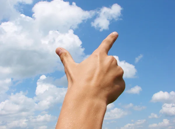 Hand gesture pointing against blue sky — Stock Photo, Image