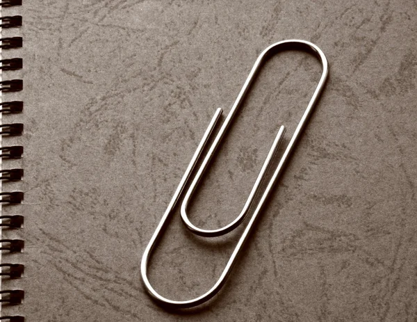 Paper clip on background with binding — Stock Photo, Image