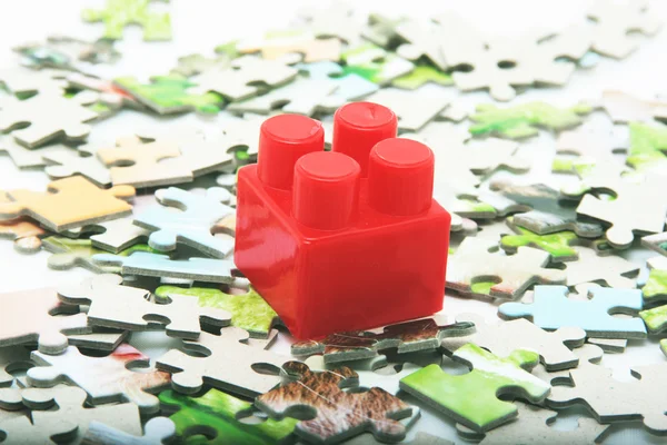 Puzzle and one red lego