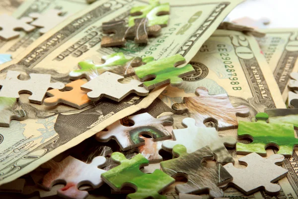 Peníze a puzzle pozadí — Stock fotografie