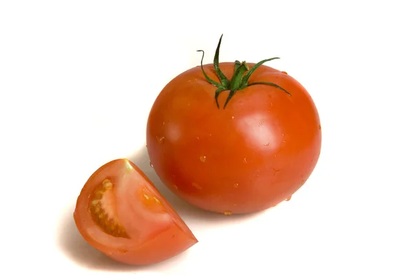 Fresh tomato with slice on white ground — Stockfoto